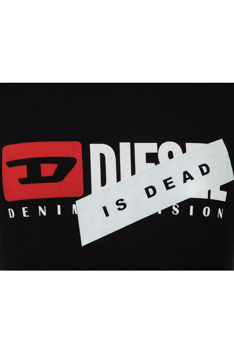 Black fabric with white and red Diesel logo partially covered by white tape reading 'IS DEAD'